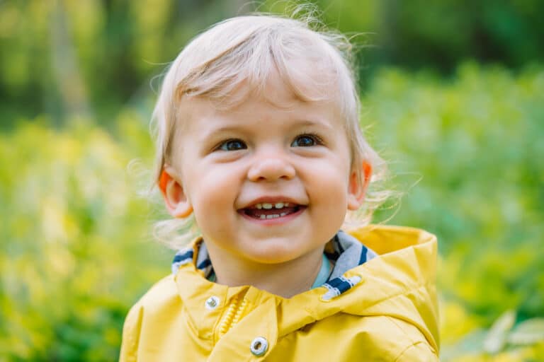 lovely-baby-smiling-in-yellow-raincoat-boy-son-2023-11-27-05-10-05-utc